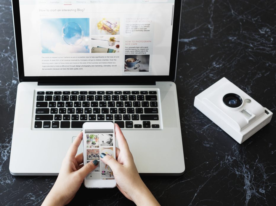 closeup-hands-using-mobile-phone-computer-laptop-black-marble-table